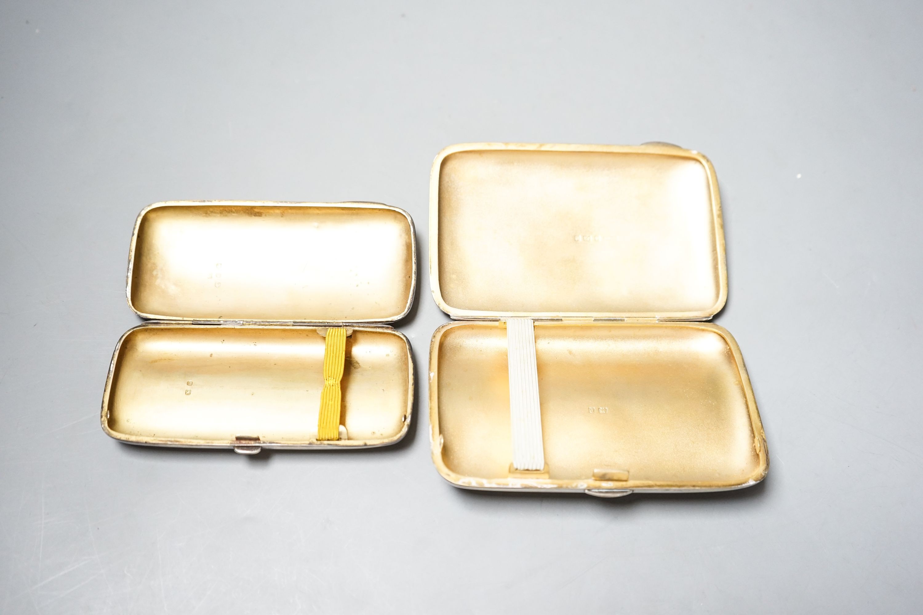 A late Victorian engraved silver cigar case, 13cm and a later silver cigar case, gross 11.5oz.